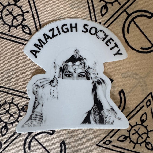 Sticker with 'Amazigh Society' text and a black and white illustration on a patterned background
